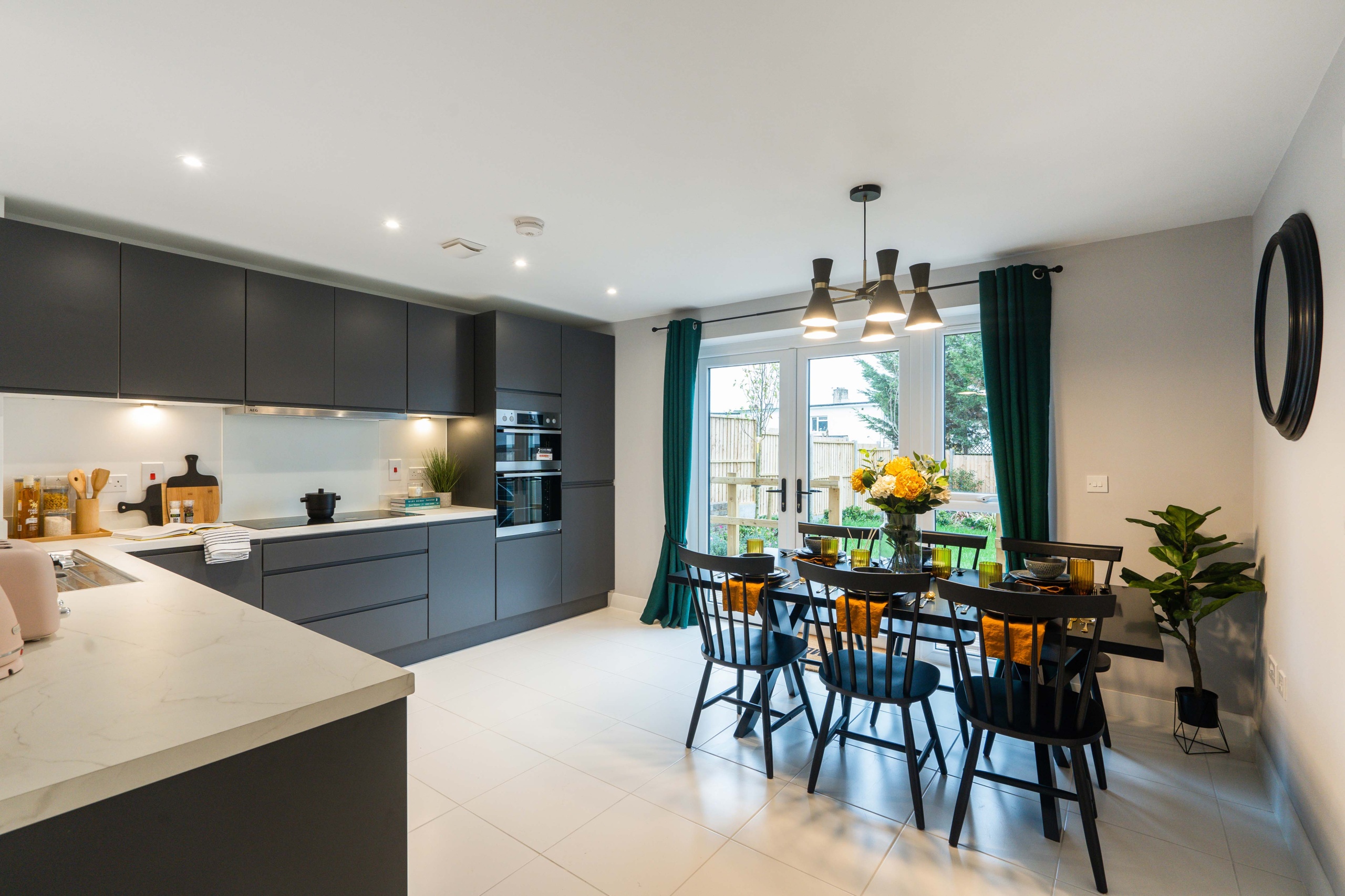 Modern kitchen with grey cabinets and white counter tops and walls