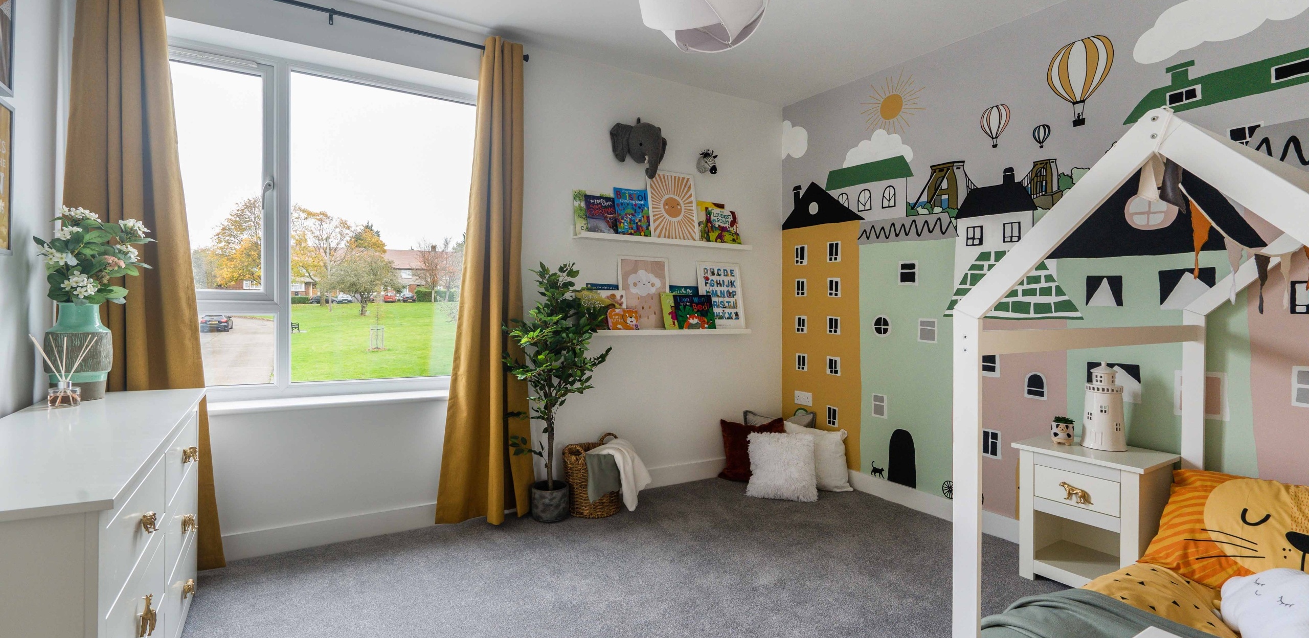Children's bedroom with a large painting of buildings and structures on the wool