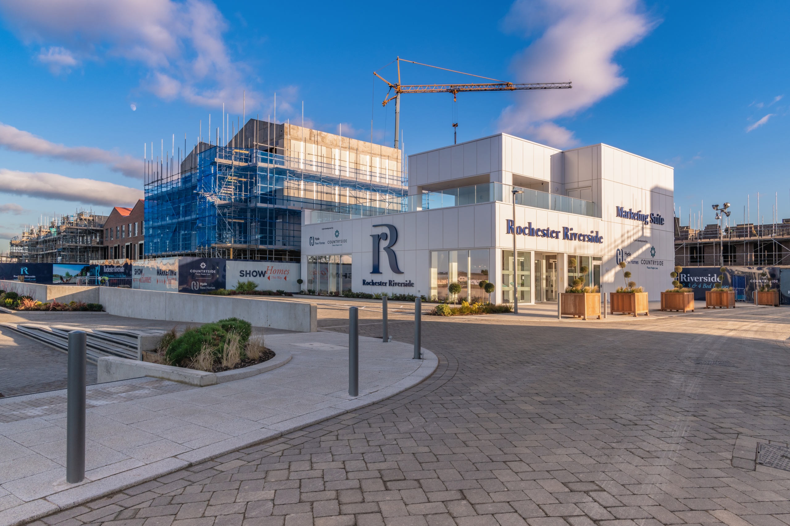 Large marketing suite next to a construction site that has a crane