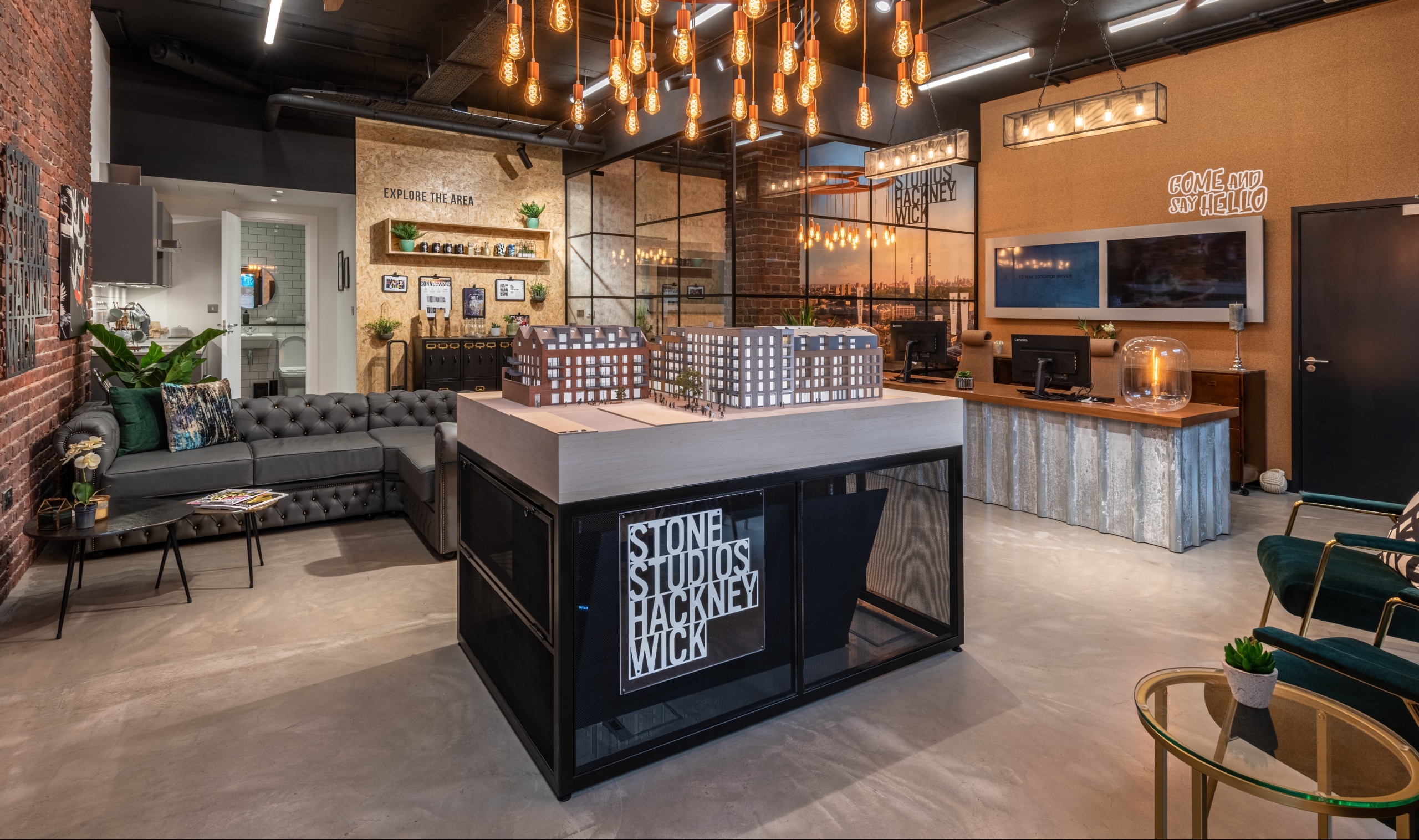 Marketing suite with a large 3D model of the development in the centre and seating areas around the outside of the room