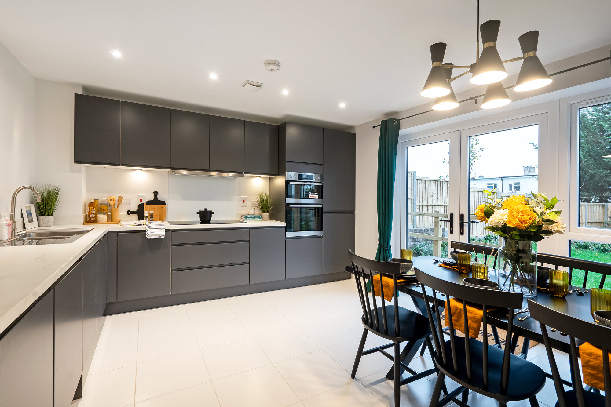 Grey set of table and chairs in modern white kitchen