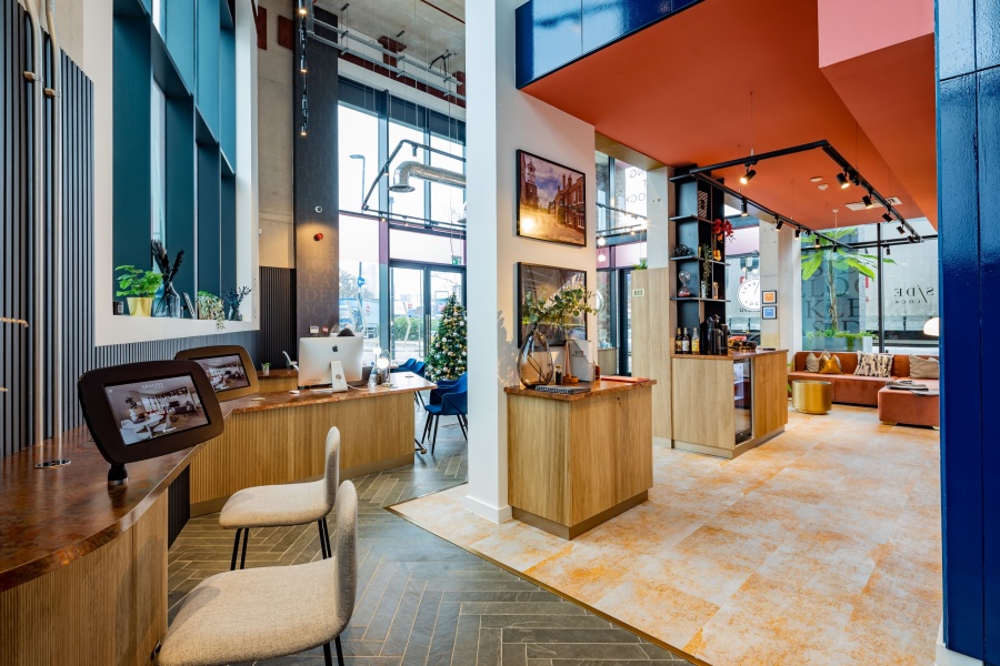 Bright and colourful communal area with lots of seating and a drink making station