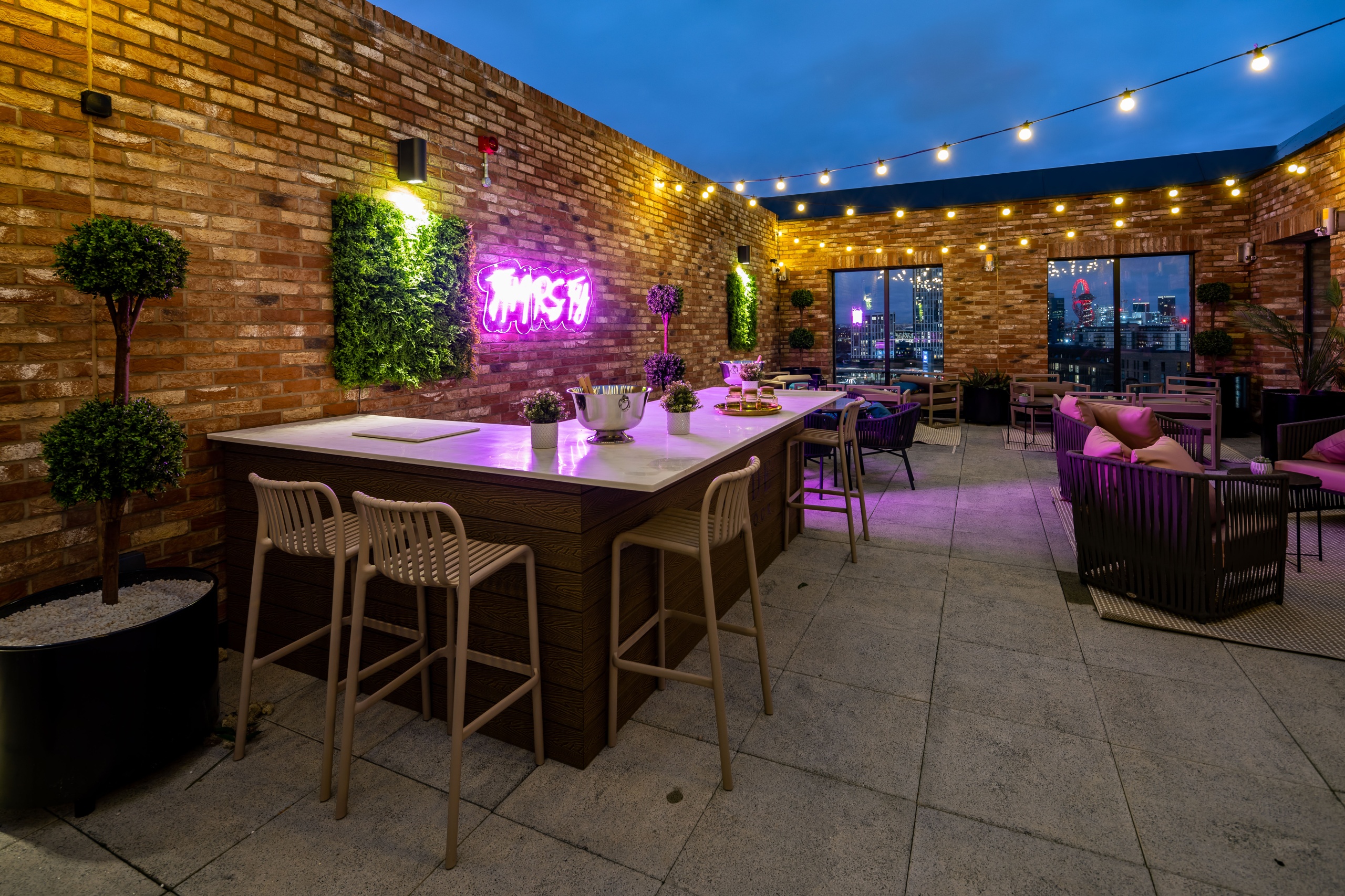 Rooftop terrace with bar and lots of seats that overlook the city