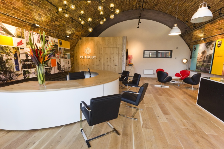 Office space with a large curved desk and coffee table with seating around it