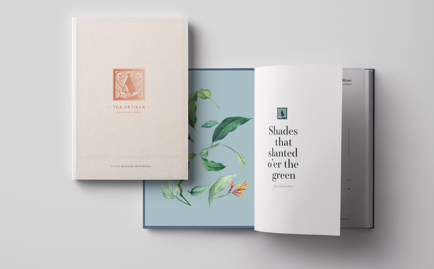 Closed book placed on top of an open book that has art work in it