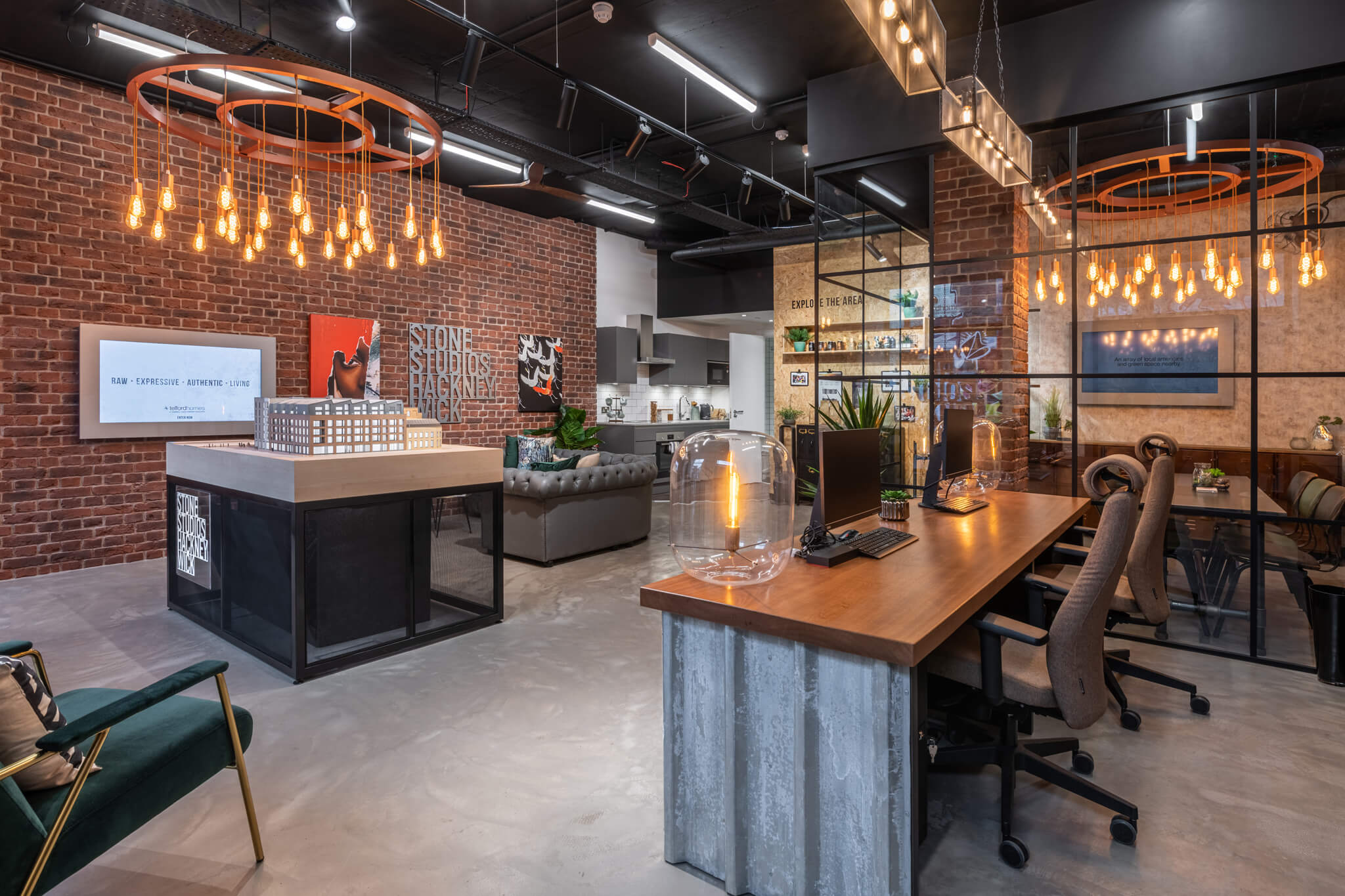 large room with multiple seating areas, a meting room and a kitchen showroom