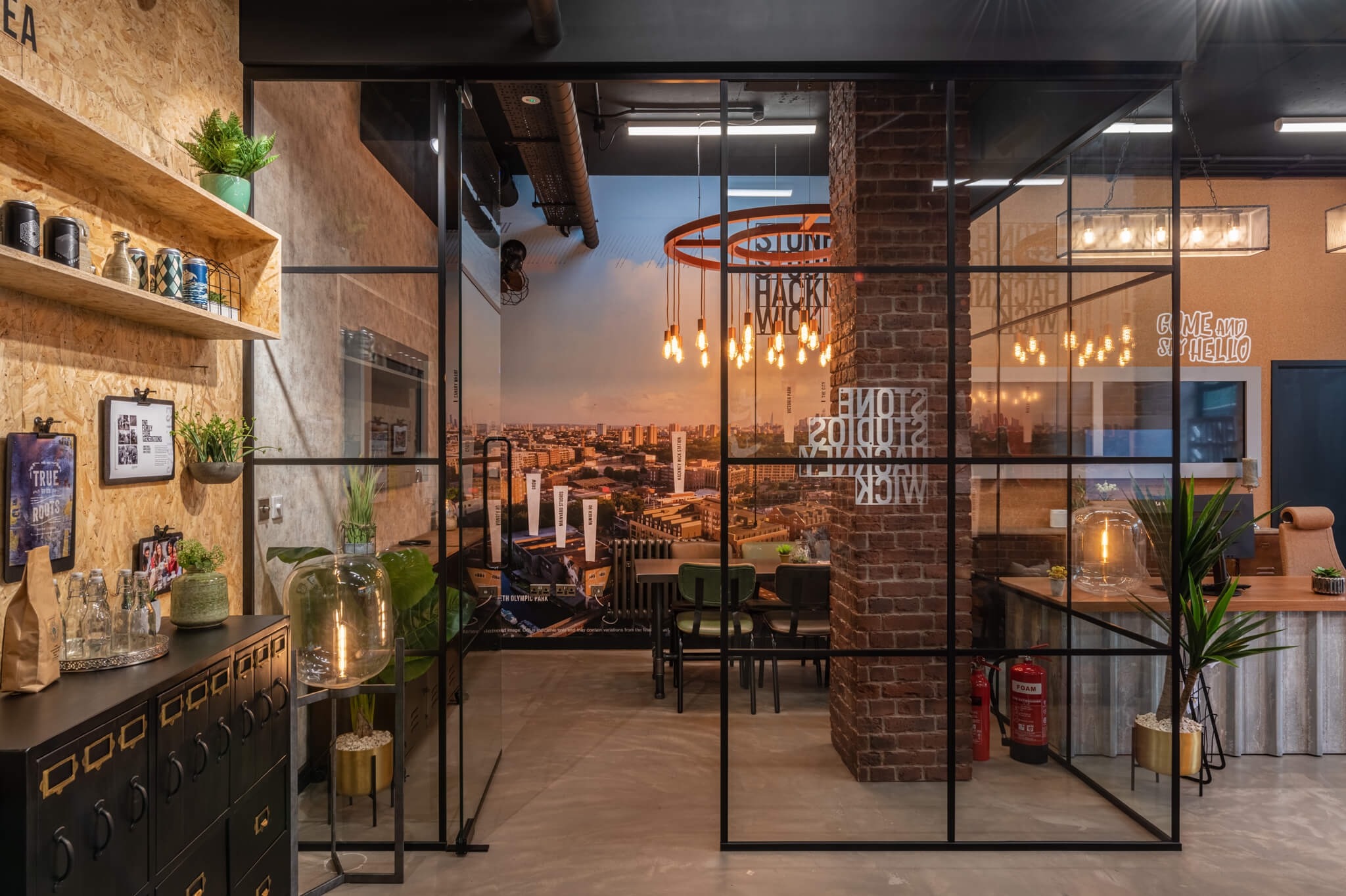 table in the middle of a room and a large chandelier above it