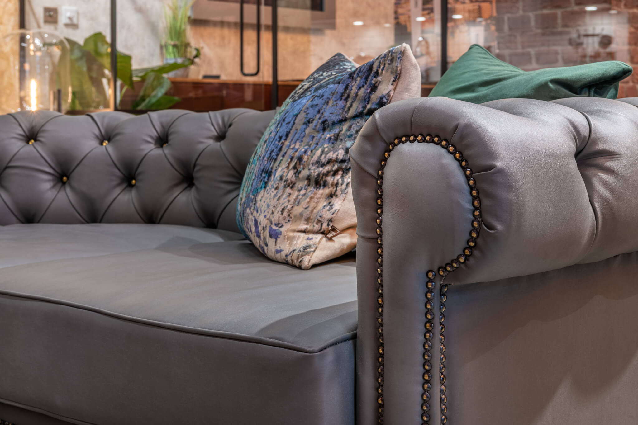 Grey antique sofa with cushions on it