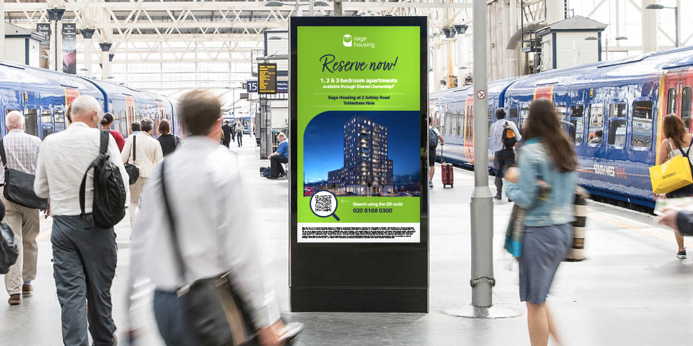 advert board in the middle of a train station advertising a new development