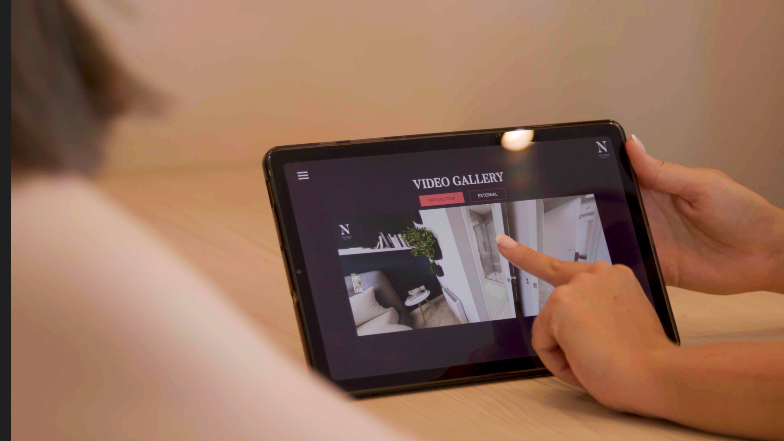 woman pointing at a picture on a tablet