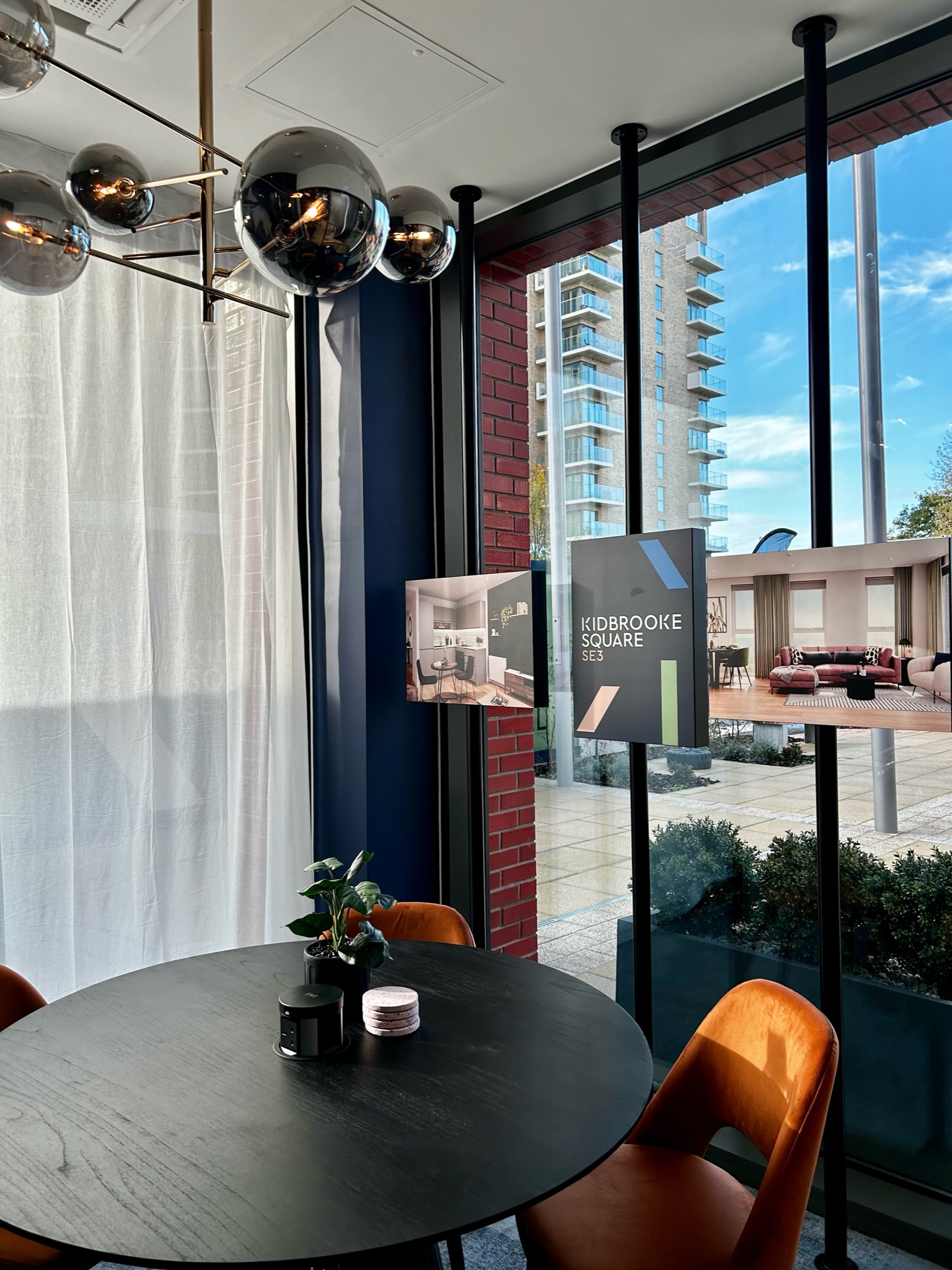 marketing suite with a table in the corner next to images of the development that is being showcased