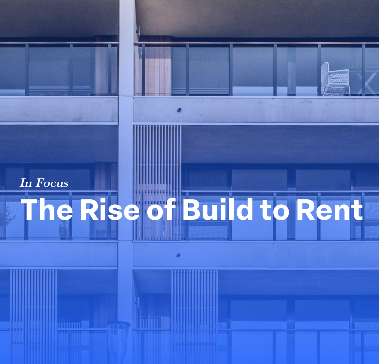 A modern apartment building with glass balconies and wooden panel accents, featuring the title 'In Focus: The Rise of Build to Rent' in bold white text against a blue overlay. A circular logo with the letter 'F' is in the upper right corner.